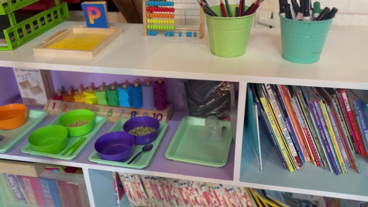 Classroom shelves with an abacus, counting blocks and storybooks