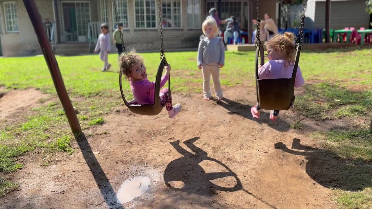 Children playing outdoors at Little Lion Pre-School